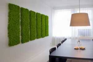 Kitchen decorated with six green colored moss panels on the wall. Product name Polarmoss Flex Element. Produced by Polarmoss Ltd.
