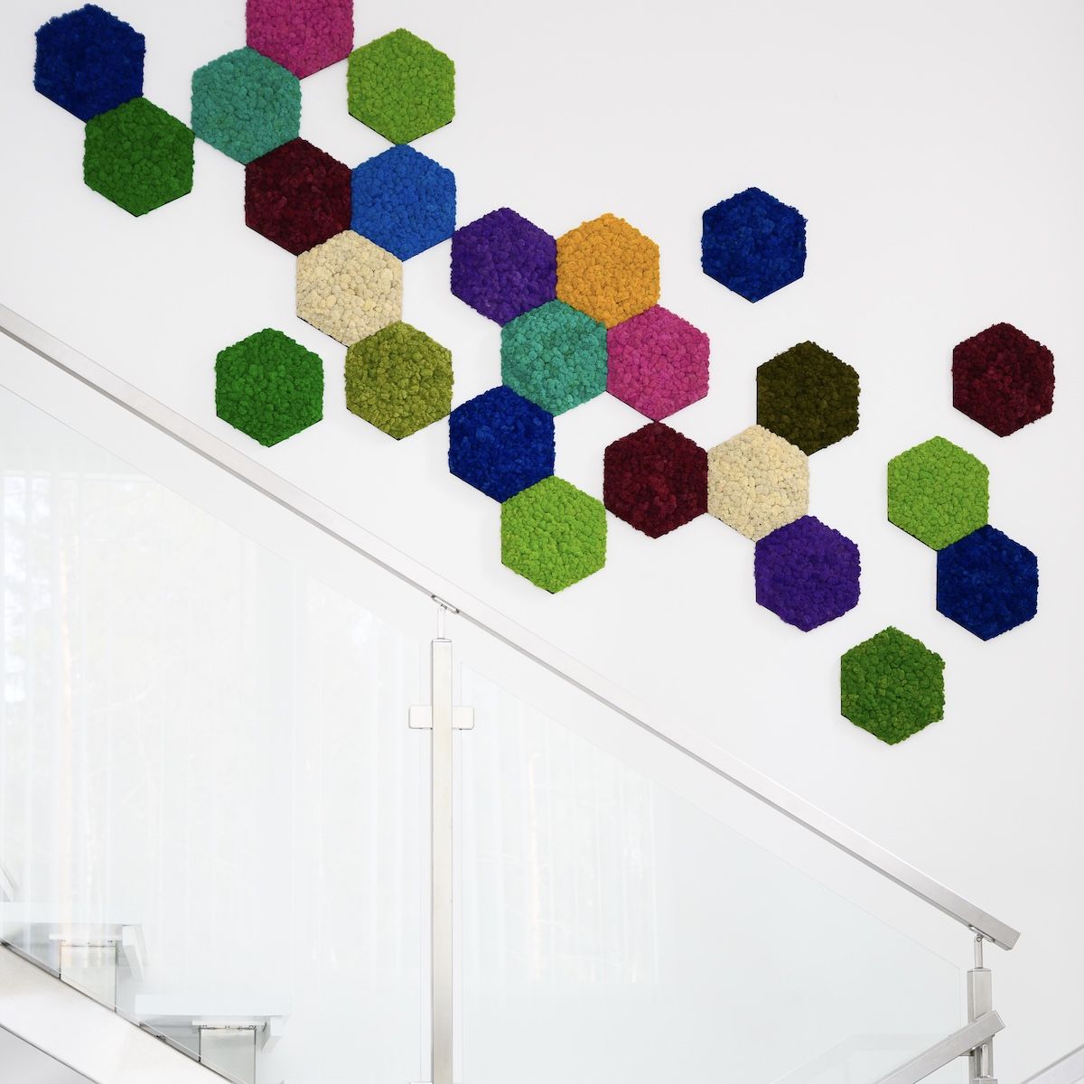 Image of several different colored moss wall products placed on a staircase wall. Product name Polarmoss Hexagon.