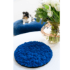 Reference image of Polarmoss Ltd. One round marine blue colored moss interior design elements on the table and Sheepdog layig on the blue soffa. Product name Polarmoss Moon.